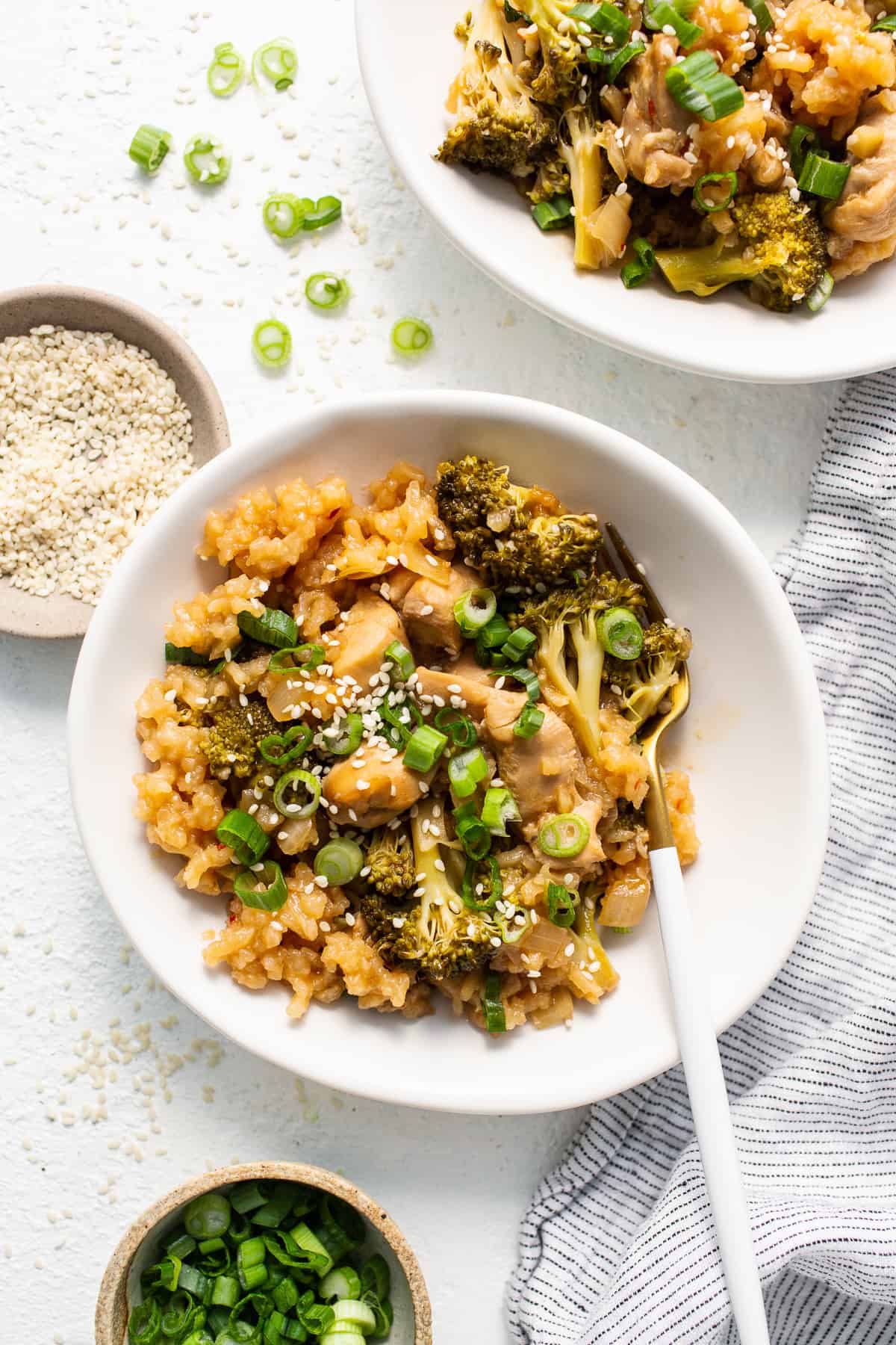 This Orange Chicken Casserole combines a classic takeout meal with easy at-home prep, made with just one dish! orange chicken casserole in bowl.