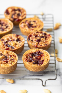 Peanut Butter and jelly cups on a metal rack.