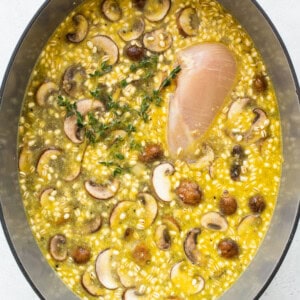 All of the ingredients for chicken soup in a Dutch oven.