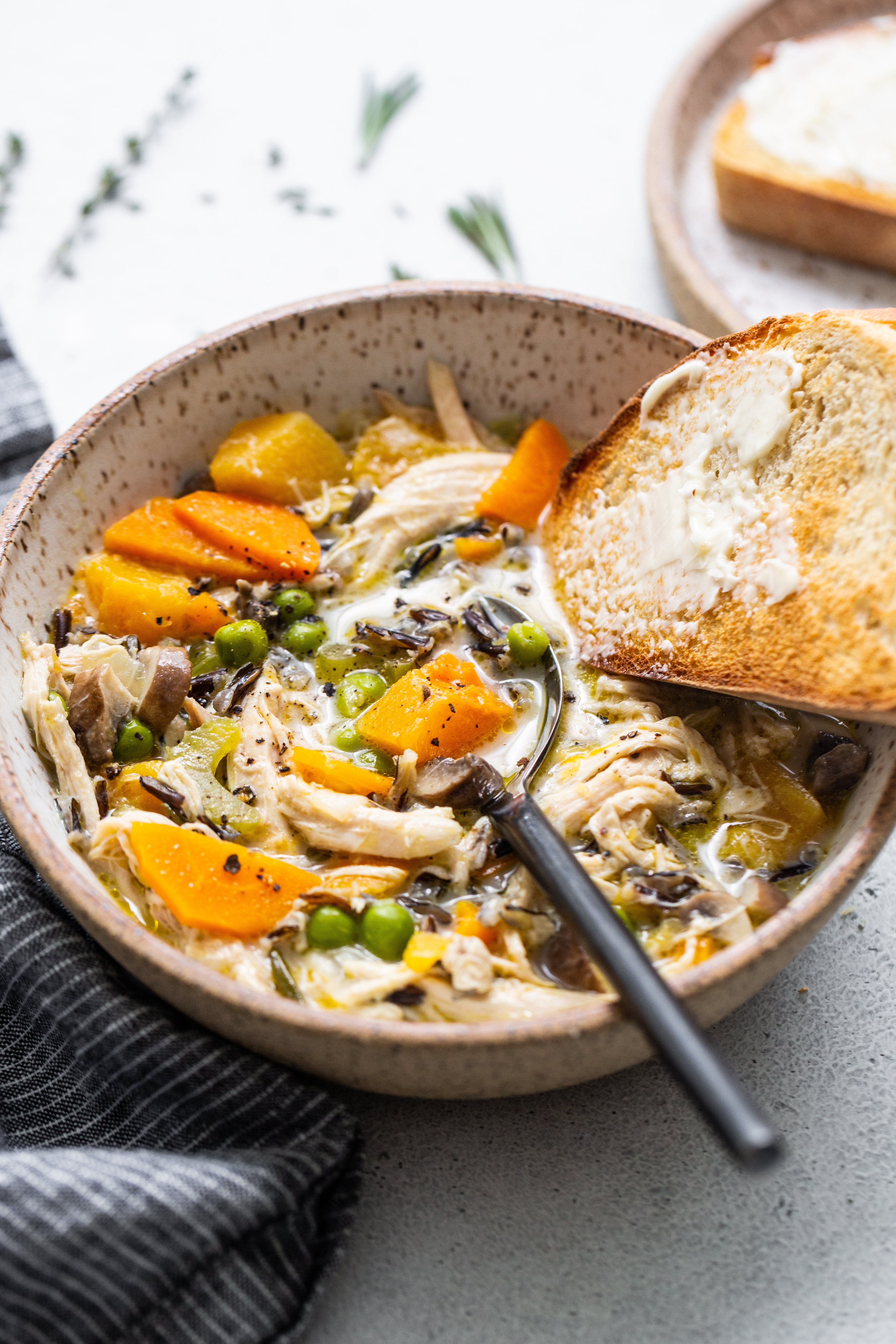 This Turkey Wild Rice Soup is rich, creamy, and cozy. It's the perfect soup for holiday leftovers and is super easy to store and enjoy later. Turkey wild rice soup in a bowl.