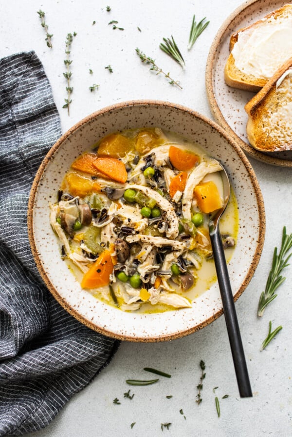 A bowl of turkey soup with vegetables.