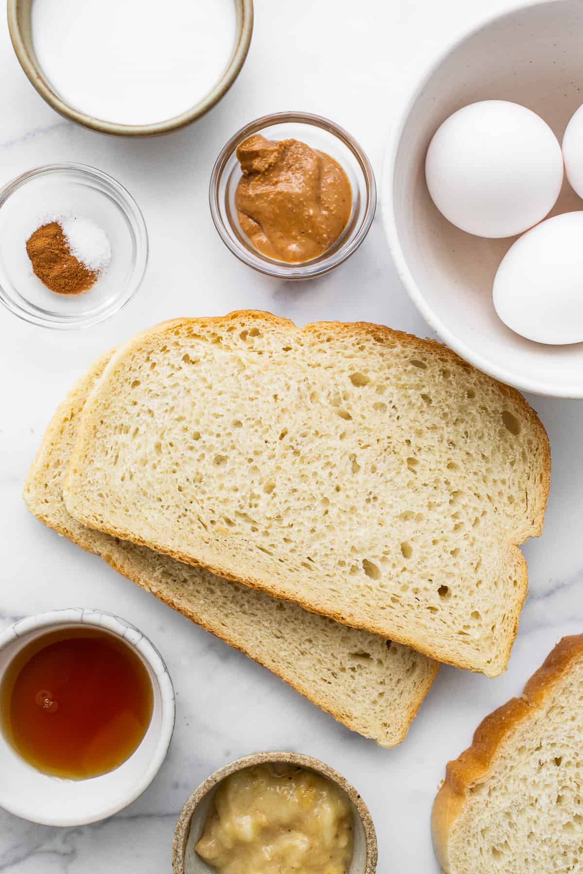 This air fryer chunky monkey French toast is a sweet breakfast eater's dream! The bread gets soaked in an egg mixture of banana, maple syrup, cinnamon, and peanut butter for an ultra-rich French toast topped with chocolate, roasted walnuts, and sliced bananas. Ingredients for air fryer chunky monkey french toast.