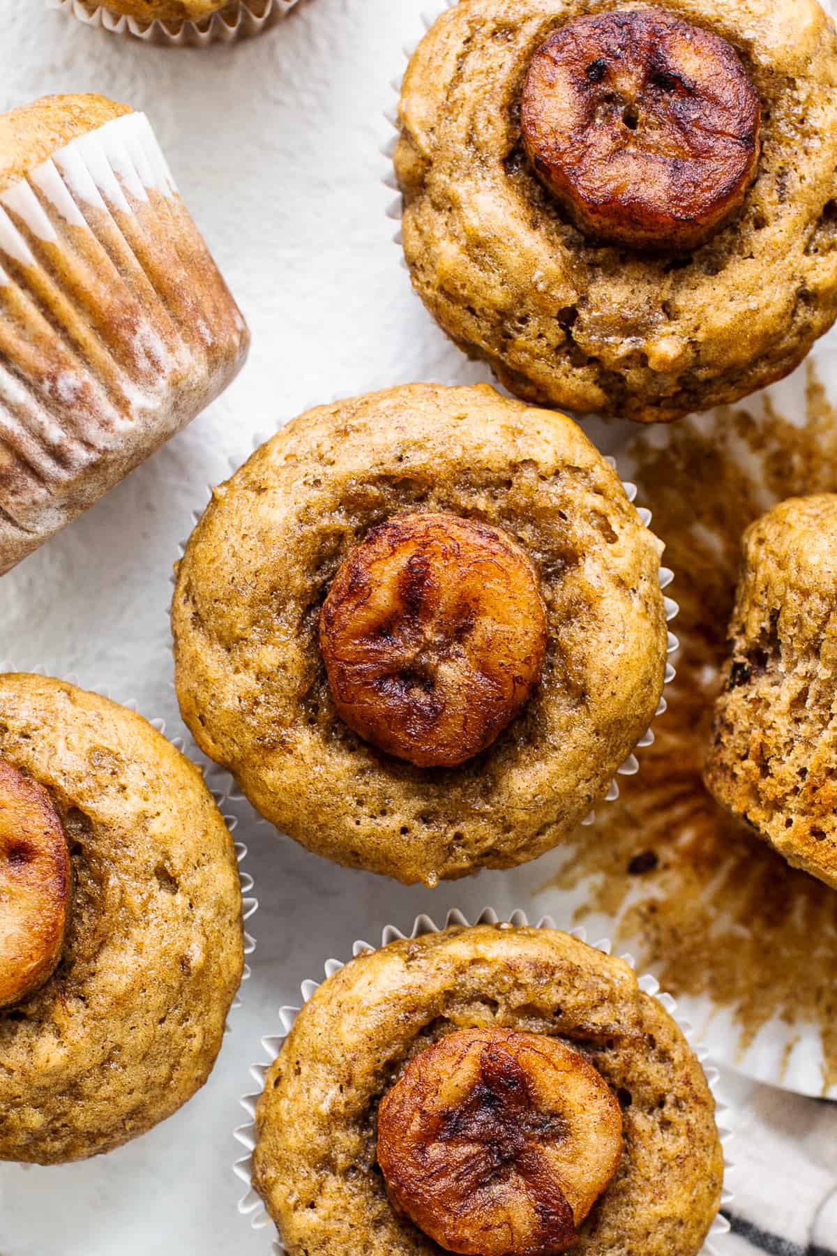 Bananas Foster Muffins are made with a delicious banana muffin base and sweet, caramelized bananas on top for the perfect snack. bananas foster muffin.