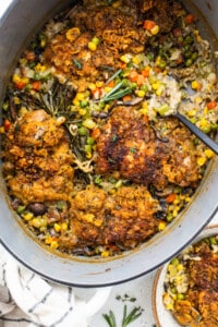 A pot with chicken and vegetables in it.