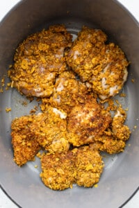 A bowl full of granola with chicken in it.
