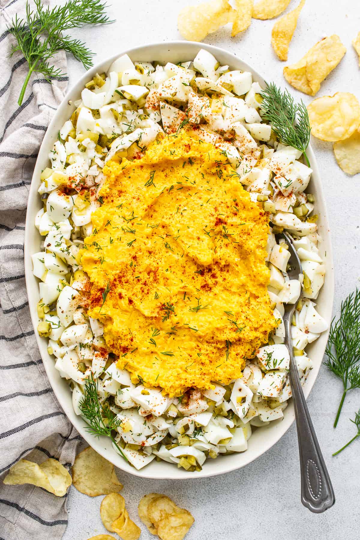 This deviled egg salad recipe is everything you love about a deviled egg, but in egg salad form! Serve as a sandwich or with chips for the ultimate dip. Deviled egg salad in a serving bowl.