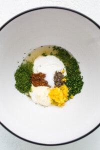 A white bowl with ingredients in it.