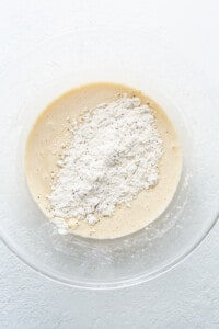 A bowl filled with flour and powdered sugar.