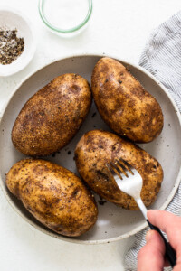 poking holes in potatoes.