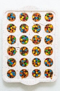 A tray of cookies with m&m's on it.