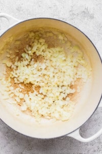 A pan with onions and garlic in it.