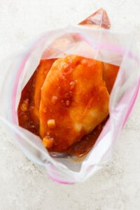 a close up of a chicken in a plastic bag.