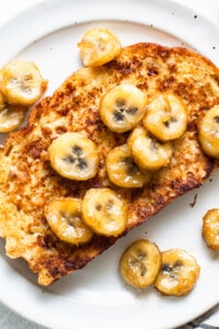 French toast with banana slices on a plate.