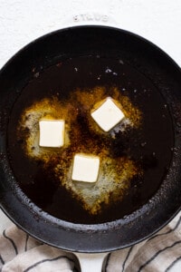 A frying pan with butter in it.