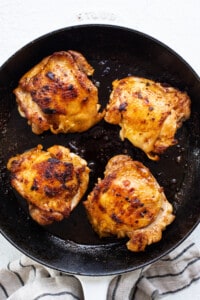 Grilled chicken breasts in a skillet.