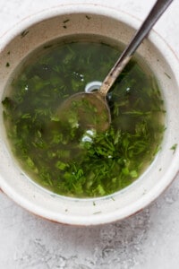 a bowl of soup with a spoon in it.