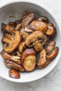 roasted mushrooms in a white bowl.