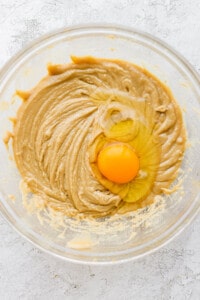 a bowl of peanut butter with an egg in it.
