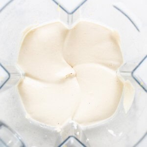 a food processor filled with cream cheese.