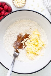 A bowl filled with ingredients for a cake.