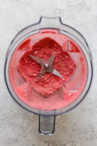 A food processor filled with a pink substance.