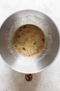 A metal pan with brown liquid in it.