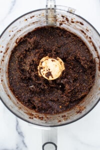 A food processor filled with a brown mixture.