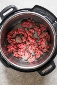 An instant pot with meat in it.