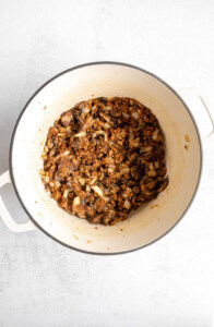 A pot filled with a mixture of mushrooms and onions.