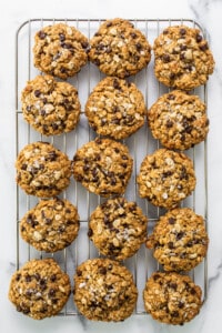 Chocolate chip oatmeal cookies on a cooling rack.