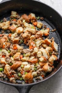 A skillet filled with stuffing and vegetables.