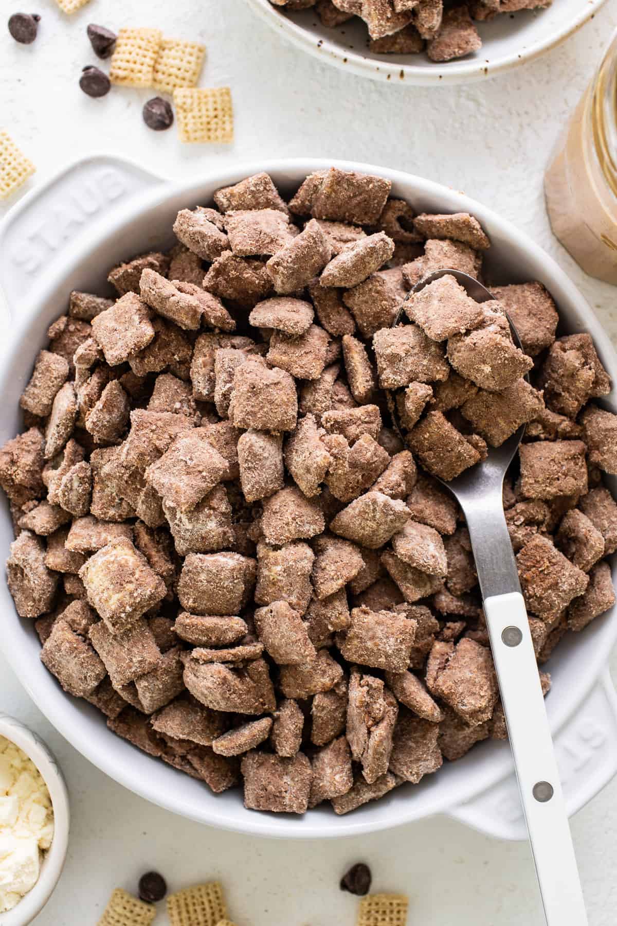 Chocolate peanut butter cheetos in a bowl with a spoon.