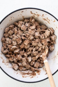 A bowl filled with a mixture of granola and chocolate chips.