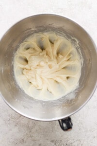 A bowl of whipped cream in a metal bowl.