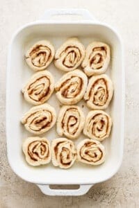 Cinnamon rolls in a white baking dish.