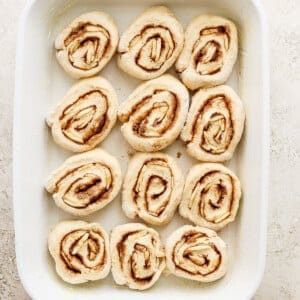 Cinnamon rolls in a white baking dish.