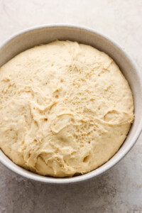 Dough in a bowl on a table.