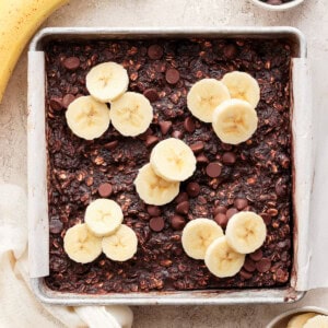 A baking pan with banana slices and chocolate chips.