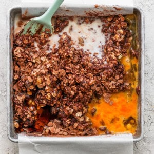 A baking pan with a scoop of granola in it.