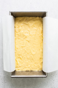 A square of yellow cake in a baking pan.