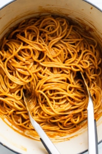 Spaghetti in a pot with two forks.