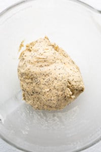 A ball of dough in a glass bowl.