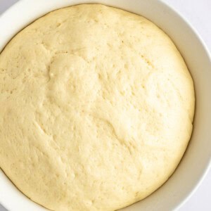 A close-up view of a bowl filled with risen dough.